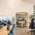 Hybrid Work in 2026 with professionals collaborating in a modern coworking workspace environment
